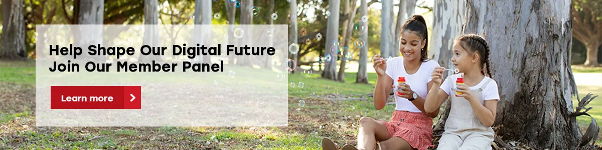 Two children sitting under trees in a park blowing bubbles, with overlaid text inviting users to join Queensland Country Bank’s Member Panel and a “Learn more” button.
